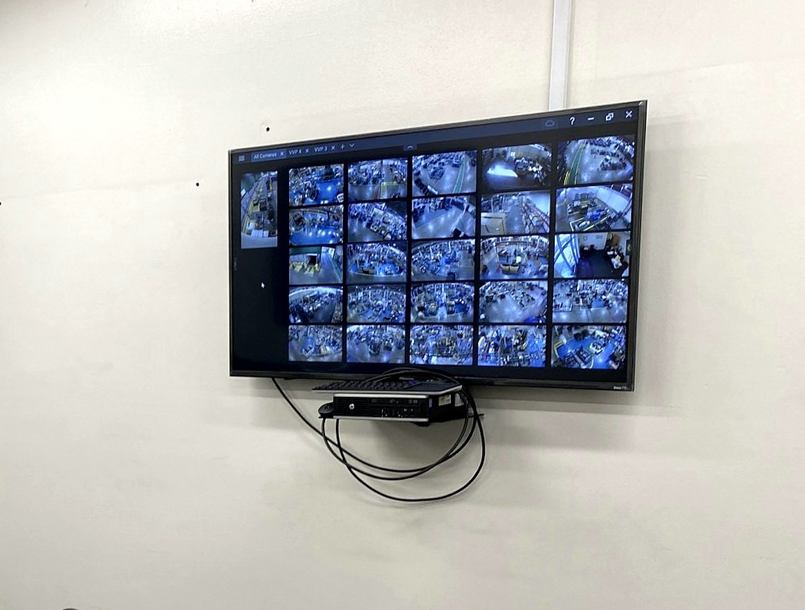 12-camera live surveillance monitor displaying warehouse security camera feeds on Acer display — remote monitoring managed security camera system Mount Clemens Michigan Macomb County — Michigan Security Systems