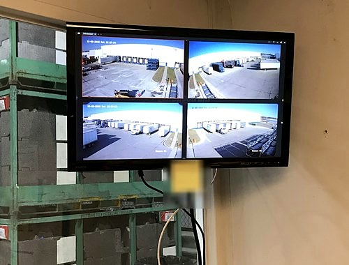 8-channel camera monitor at an office desk — Michigan Security Systems