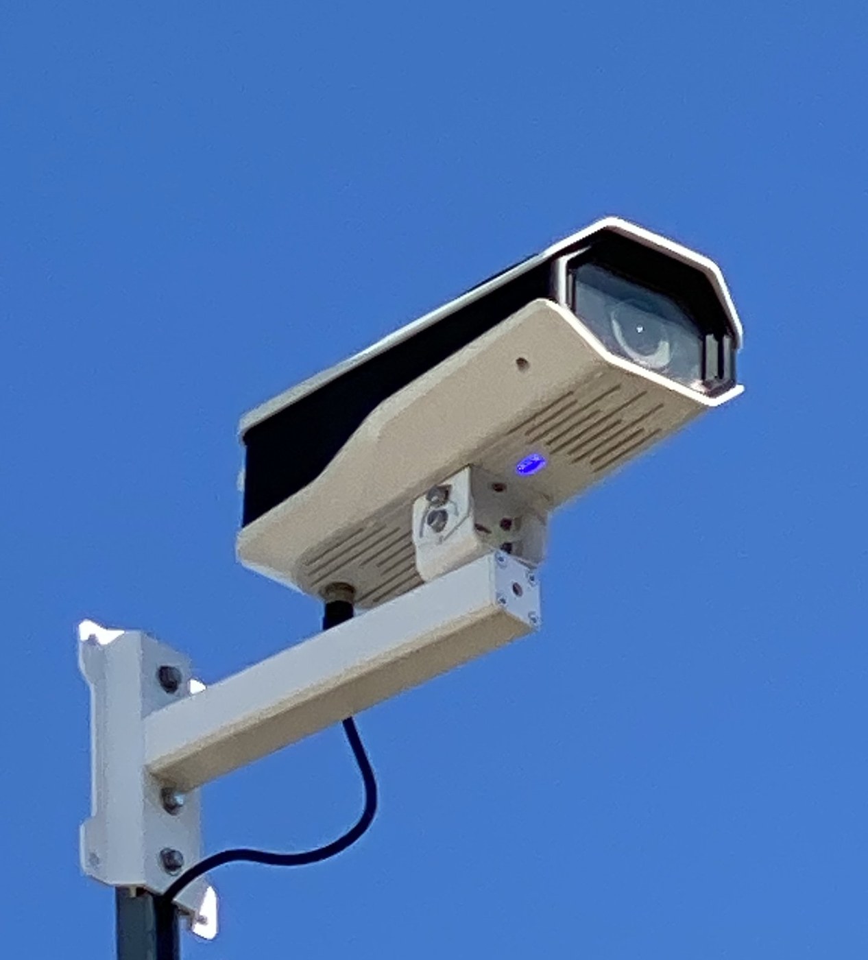 Bullet-style security camera mounted on a job site pole at a Michigan construction site, installed by Michigan Security Systems
