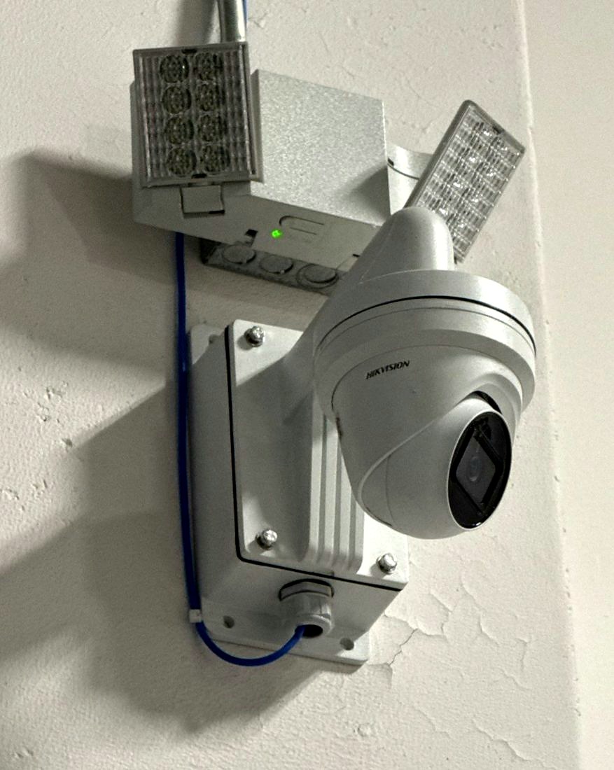 Close-up of a Hikvision turret security camera with an infrared illuminator on a junction-box mount for day and night coverage at the Chesterfield Library in Chesterfield, Michigan, installed by Michigan Security Systems