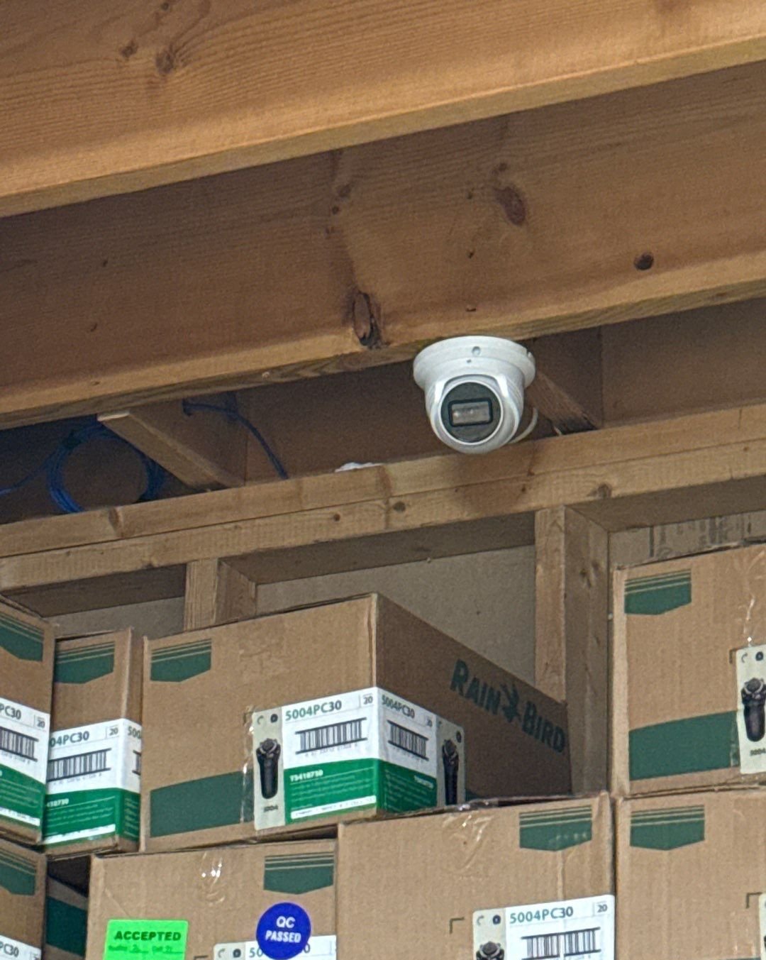 Digital Watchdog IP security camera installed over warehouse inventory in a Shelby Township, Macomb County commercial facility