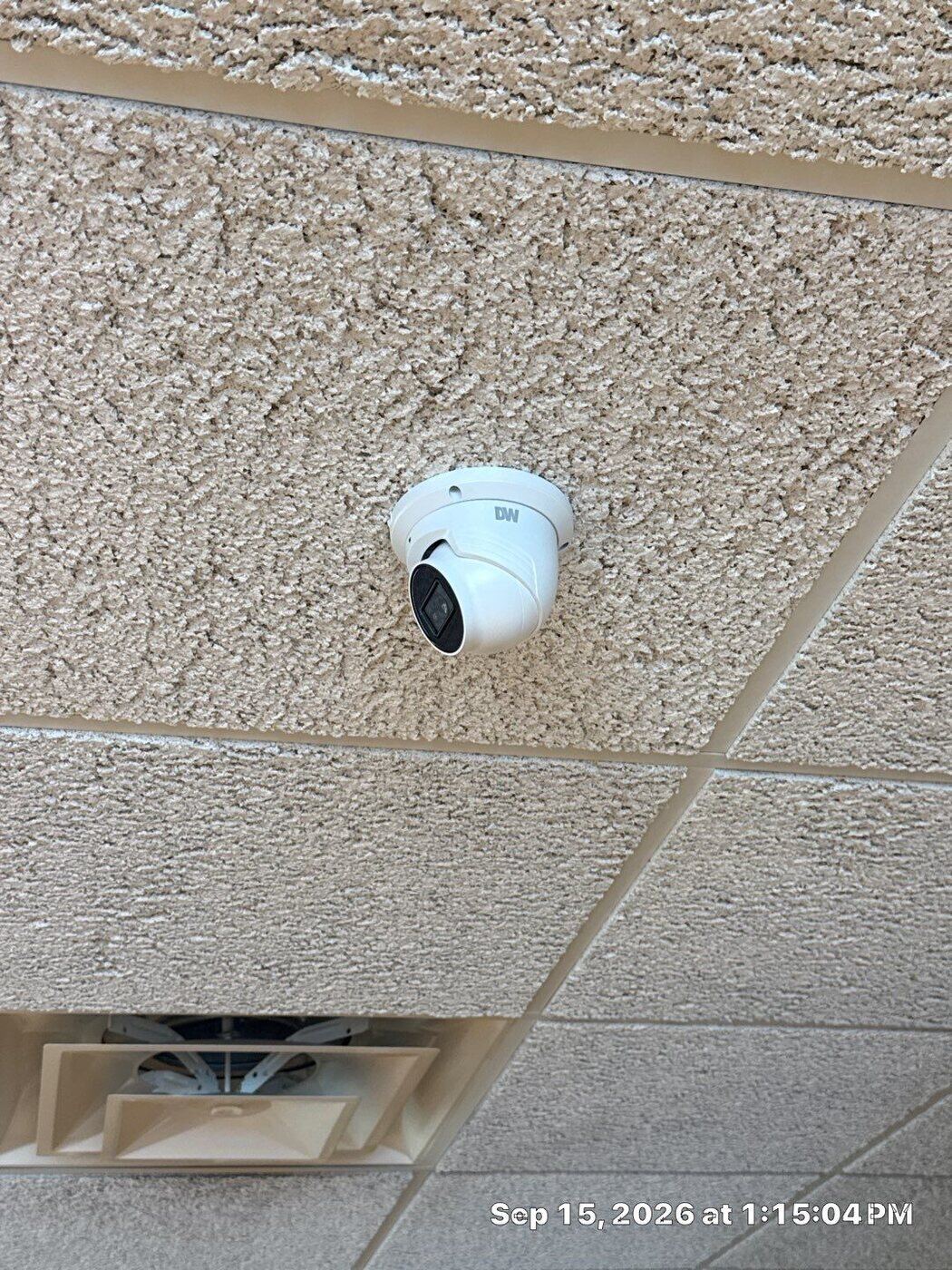 Newly installed Digital Watchdog IP dome camera on ceiling at Switch Eye Center in Taylor, Michigan — commercial security camera installation by Michigan Security Systems