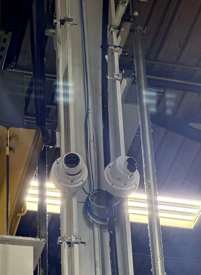 Dual Axis dome security cameras mounted on a structural column covering the production floor at the MIBA automotive manufacturing plant in Sterling Heights, Michigan, installed by Michigan Security Systems