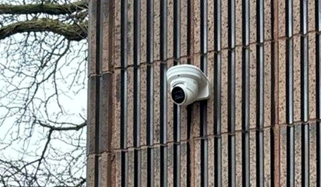 Exterior dome security camera and entry-door access control reader at the main entrance of Care of Southeast Michigan in Fraser, Michigan, installed by Michigan Security Systems