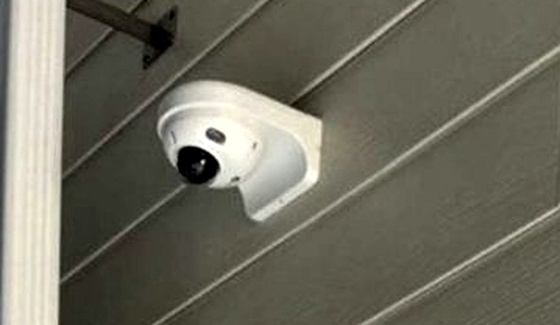 Exterior turret security camera mounted under the eave covering the entrance at The Learning Experience childcare center in Michigan, installed by Michigan Security Systems
