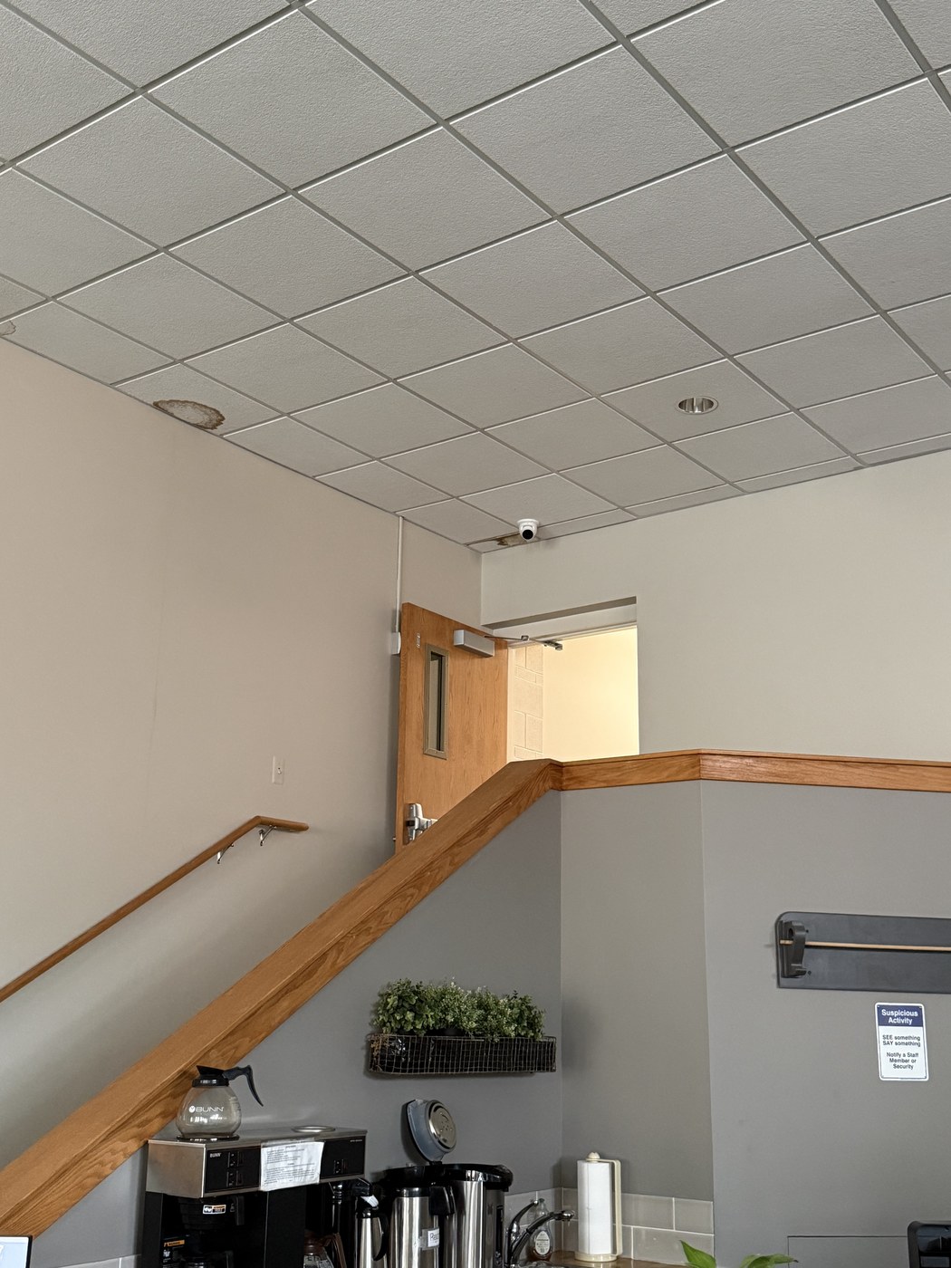 Interior dome security camera installed in a small business ceiling — affordable Michigan security systems