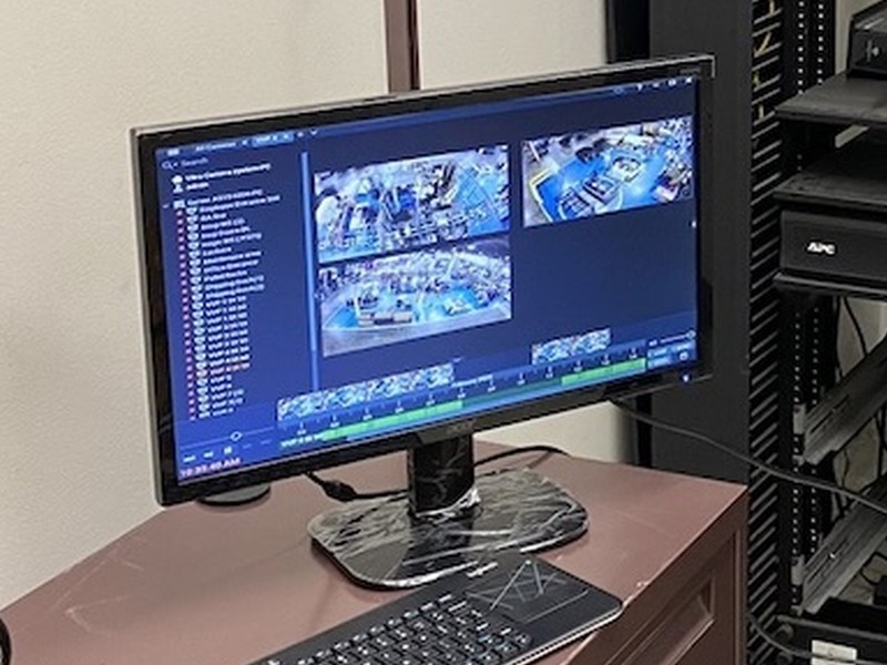 Digital Watchdog DW Spectrum video management software displaying a live multi-camera security view on a monitoring workstation, managed by Michigan Security Systems