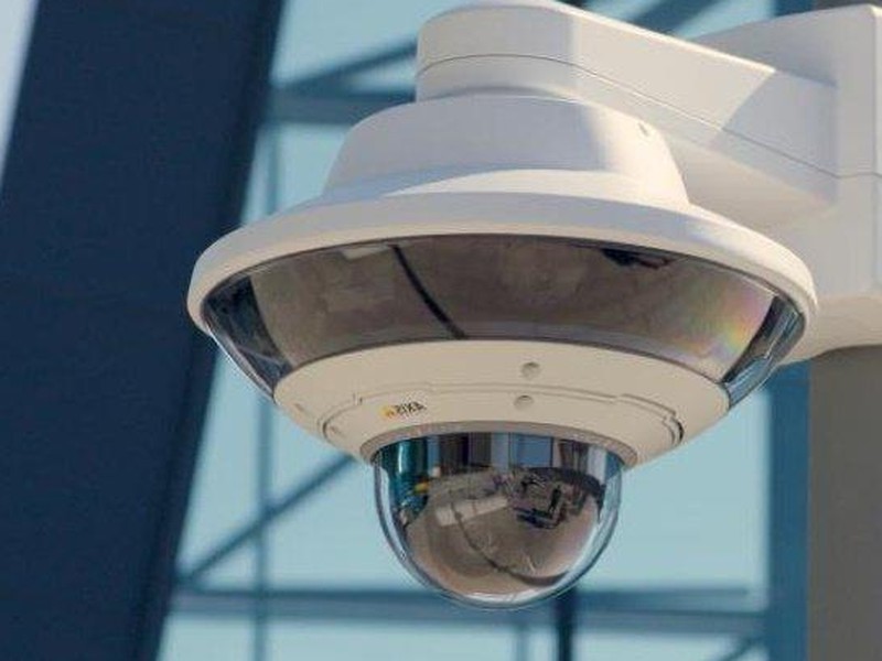 Axis Communications 360-degree panoramic dome security camera on a commercial building exterior - professional Axis camera installation by Michigan Security Systems, authorized Axis dealer serving Michigan, Ohio and Indiana