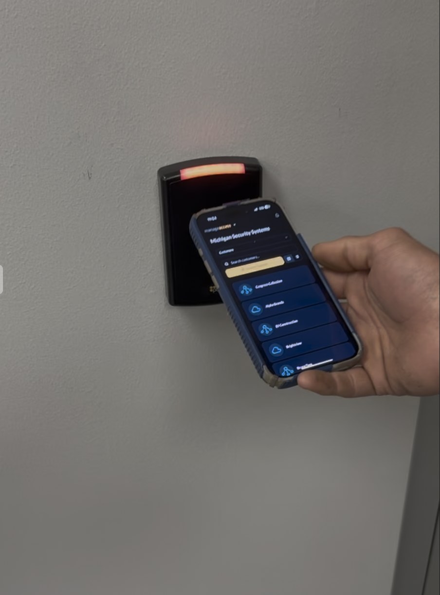 Smartphone mobile credential tapped to an access control reader at a Michigan healthcare facility — installed by Michigan Security Systems