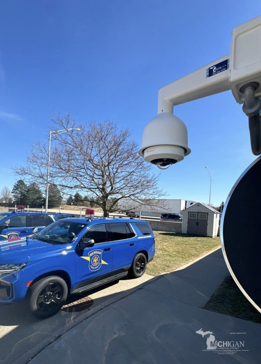 PTZ dome security camera at a Michigan State Police post with state police vehicles — Michigan Security Systems