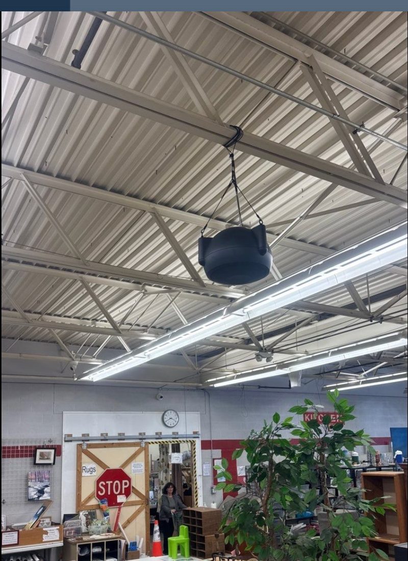 Pendant-mounted commercial ceiling speaker over the retail sales floor at the PTO Thrift Store in Lansing, Michigan, part of the in-store audio system installed by Michigan Security Systems