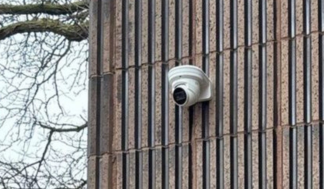 Exterior dome security camera and entry-door access control reader at the main entrance of Care of Southeast Michigan in Fraser, Michigan, installed by Michigan Security Systems