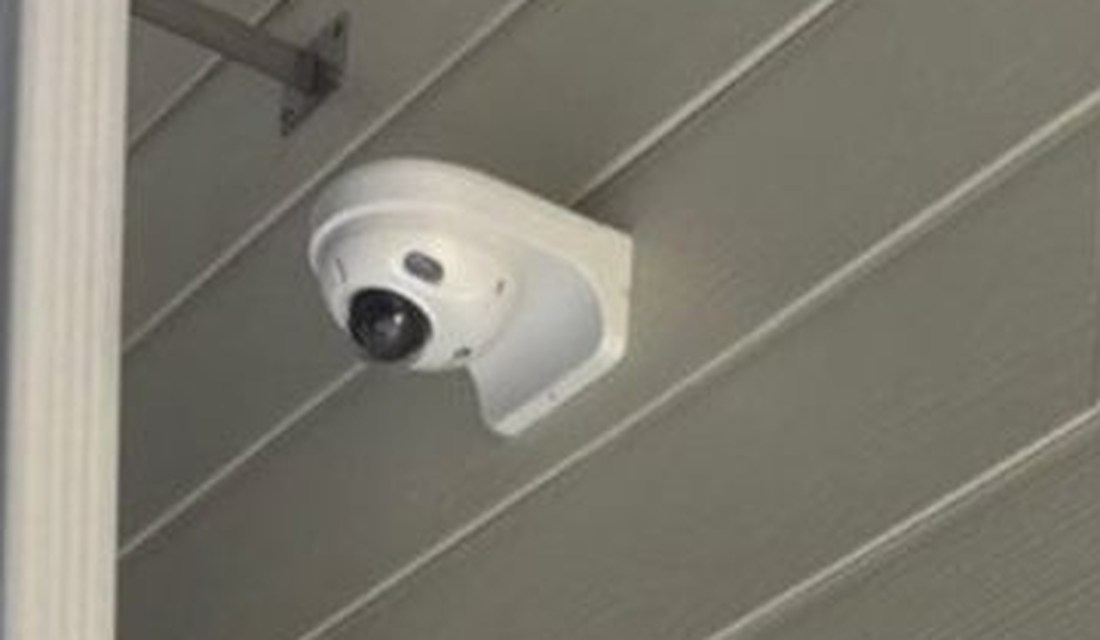 Exterior turret security camera mounted under the eave covering the entrance at The Learning Experience childcare center in Michigan, installed by Michigan Security Systems