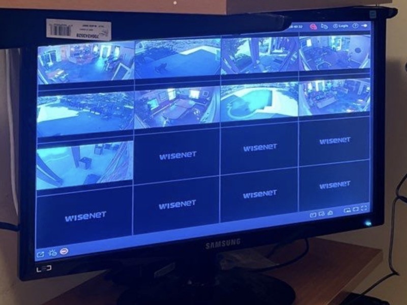 Hanwha Wisenet video surveillance system showing a live multi-camera grid on a monitoring workstation, installed by Michigan Security Systems