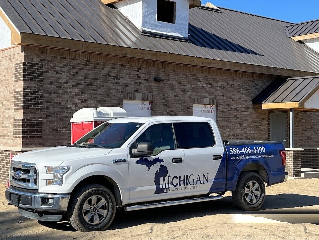 Michigan Security Systems wrapped service truck at a commercial construction jobsite — Michigan Security Systems