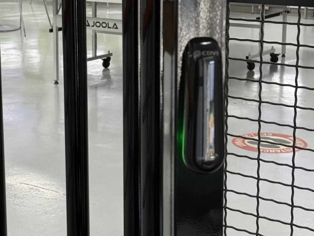 CDVI access control reader with green access-granted indicator at a commercial glazed security door, installed by Michigan Security Systems - commercial CDVI access control door installation in Michigan