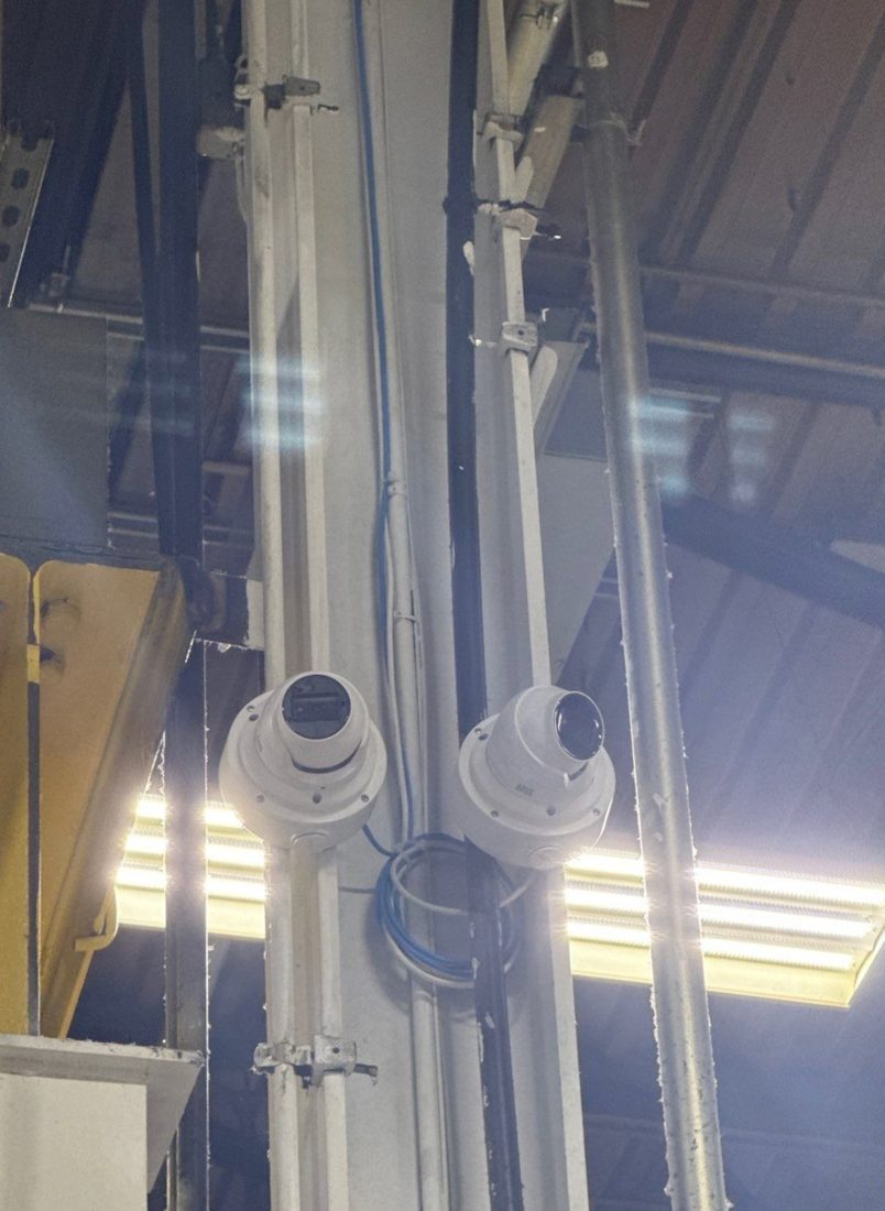 Dual Axis dome security cameras mounted on a structural column covering the production floor at the MIBA automotive manufacturing plant in Sterling Heights, Michigan, installed by Michigan Security Systems