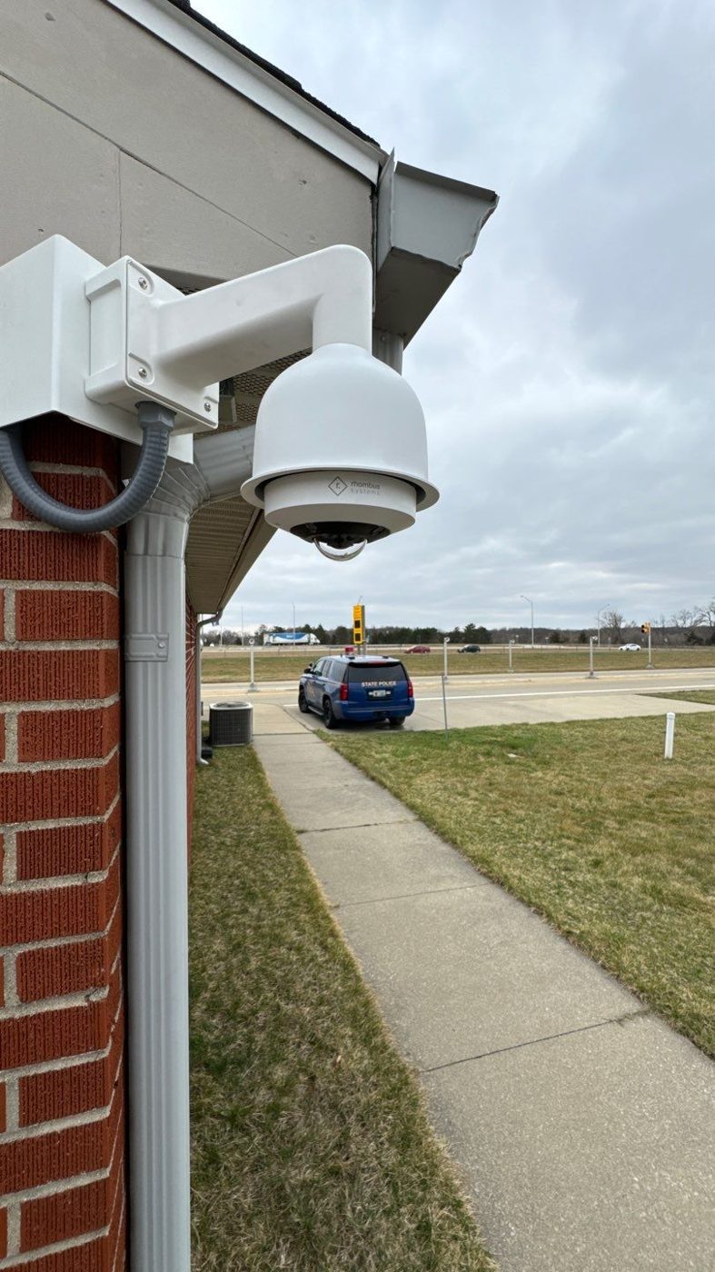 PTZ dome security camera installed on a commercial building — Michigan Security Systems commercial security camera installation