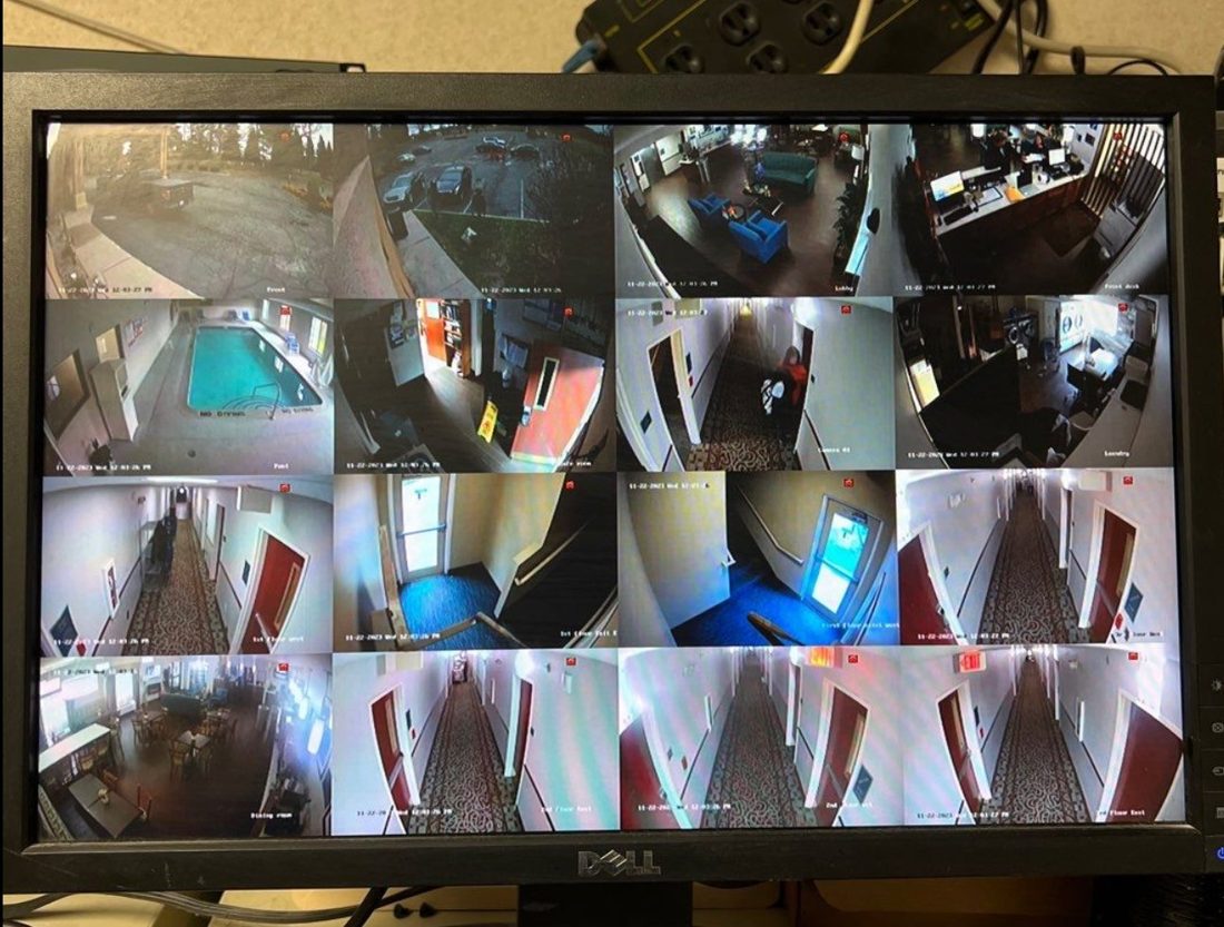 Security monitoring station showing sixteen live camera feeds of the lobby, front desk, pool, hallways, dining room, and parking lot at the Best Western hotel in Port Huron, Michigan, installed by Michigan Security Systems