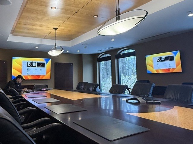 Commercial boardroom with dual displays and in-ceiling speakers — Michigan Security Systems