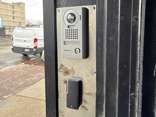 Aiphone video door station with camera beside a PDK access reader — Michigan Security Systems