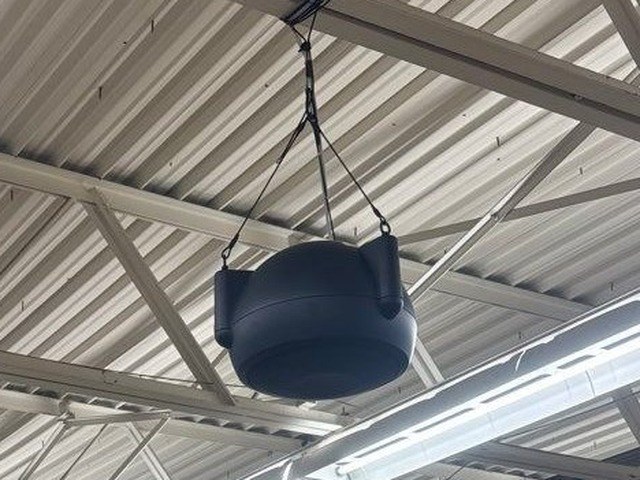 Commercial pendant loudspeaker on an open steel-truss ceiling — Michigan Security Systems