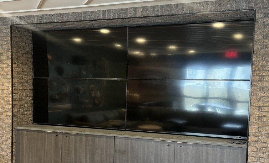Multi-screen commercial video wall in custom millwork — Michigan Security Systems