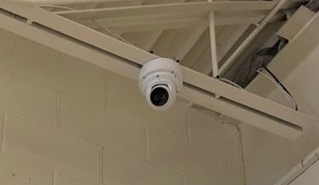 Dome security camera mounted high on the wall covering the retail floor for loss prevention at the PTO Thrift Store in Lansing, Michigan, installed by Michigan Security Systems