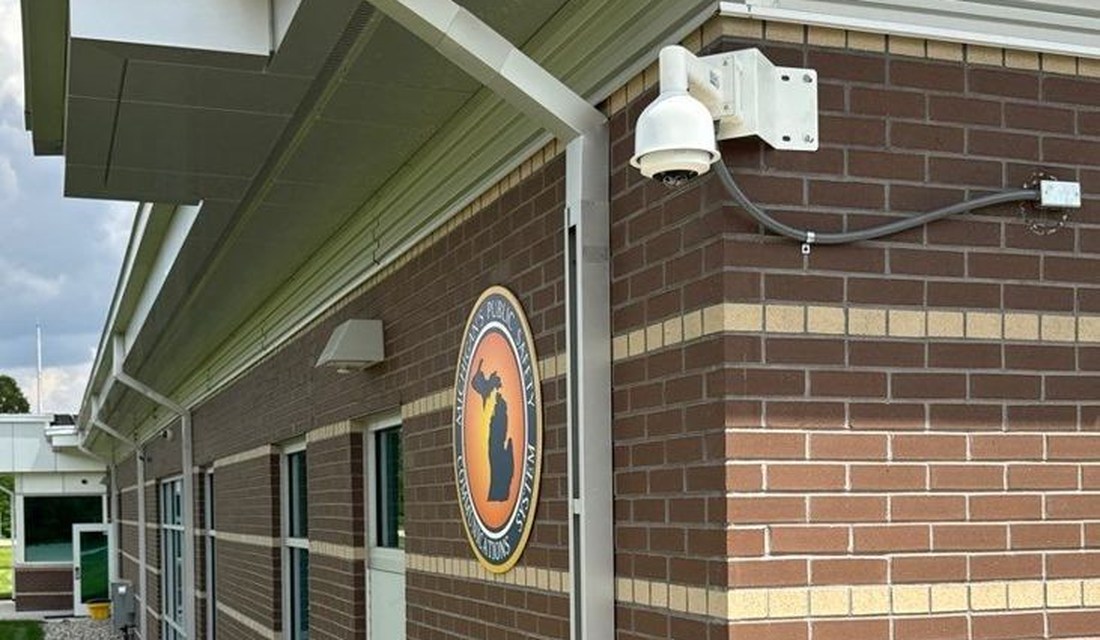 Rhombus PTZ dome security camera mounted on a public safety central dispatch building exterior, installed by Michigan Security Systems at a Michigan State Police facility