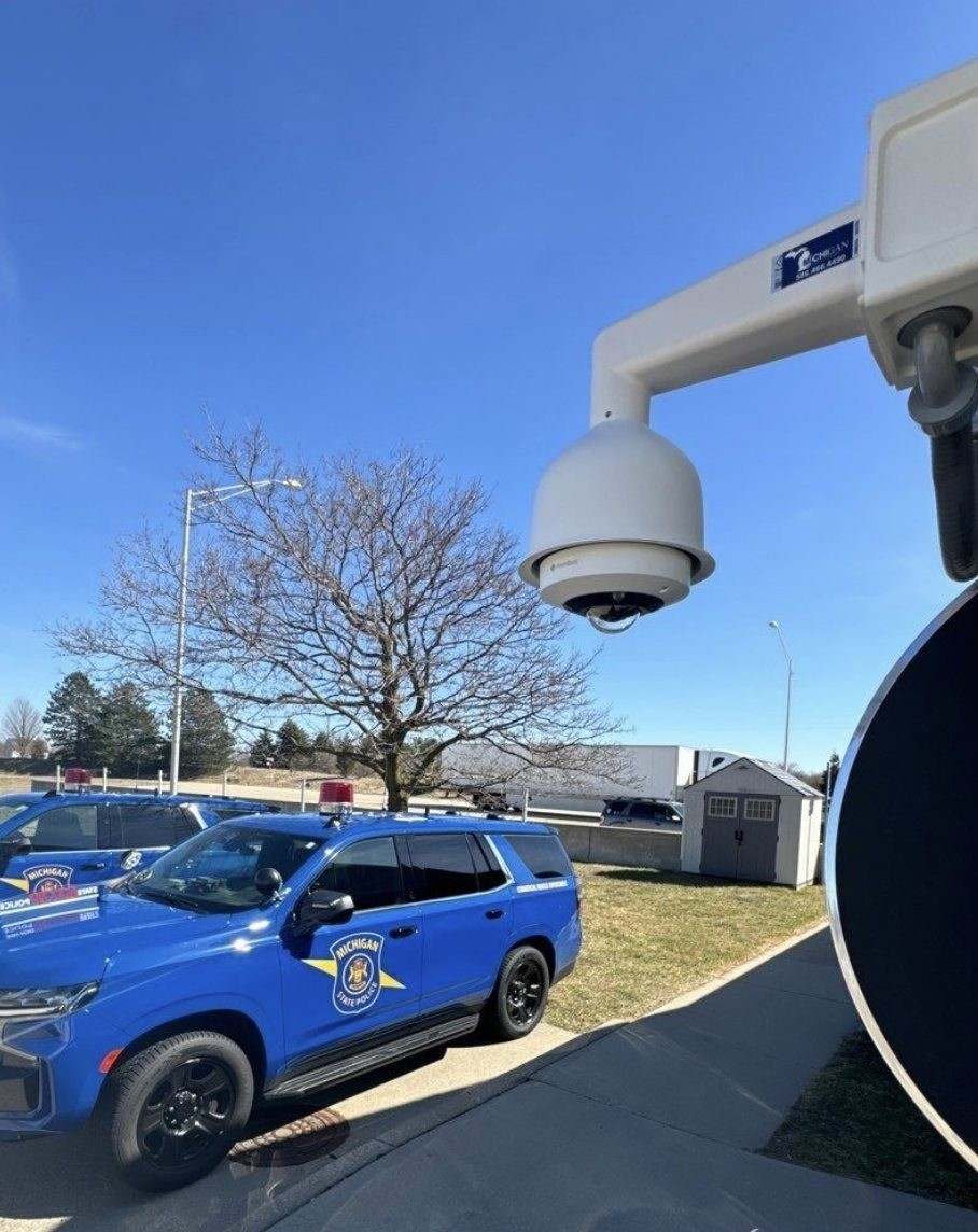 PTZ dome camera and Michigan State Police cruisers at a post facility — Michigan Security Systems