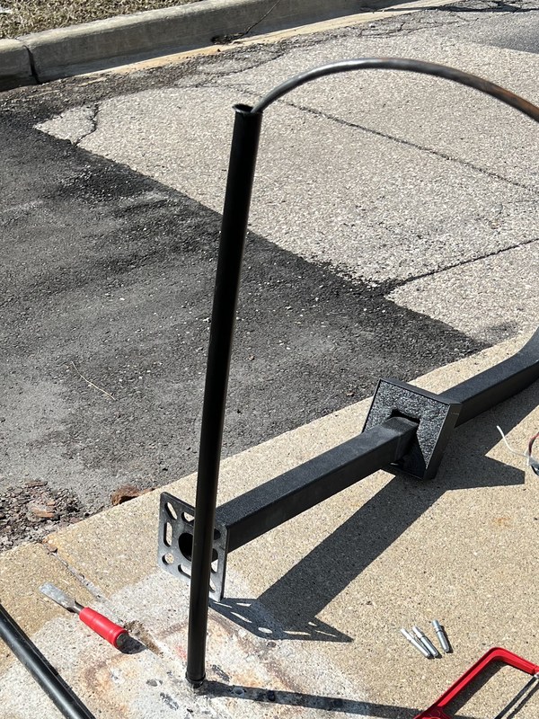 Access control gooseneck arm and base plate prepped on the ground by Michigan Security Systems