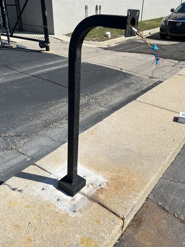 Access control gooseneck arm installed upright on a concrete base by Michigan Security Systems