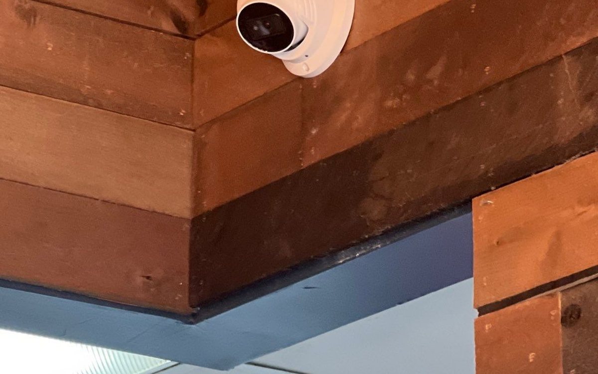 Dome camera at a small-business covered entrance — Michigan Security Systems