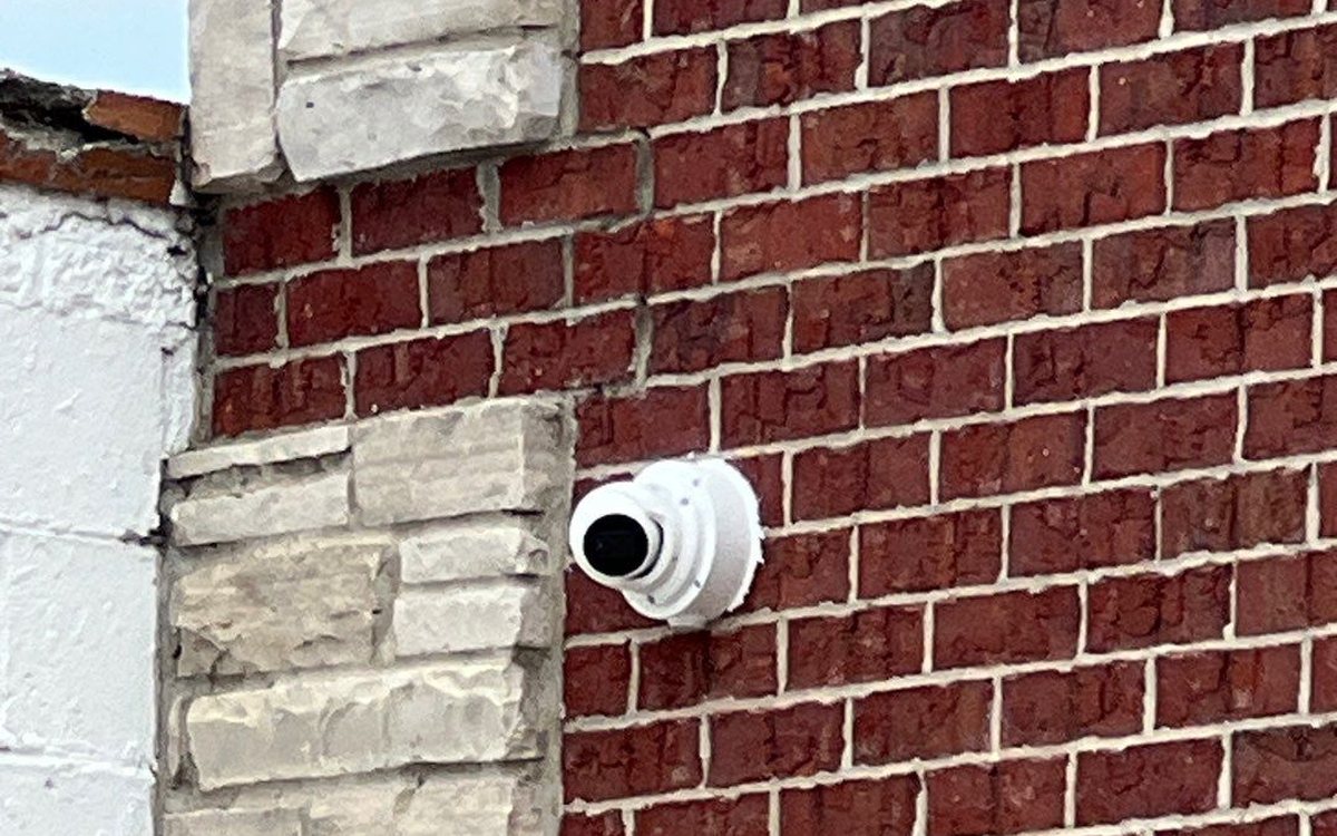 Security camera on a Michigan small-business brick storefront — Michigan Security Systems