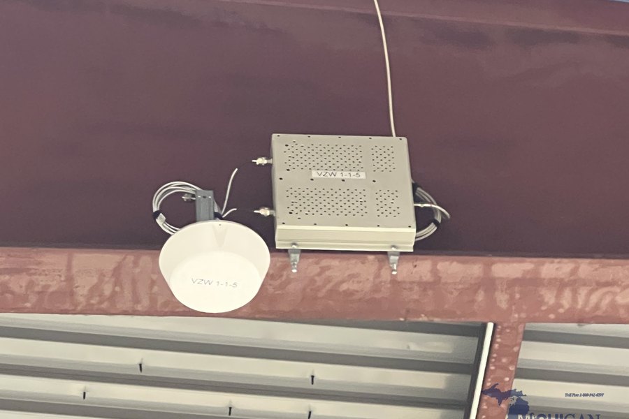 Cellular signal booster and DAS antenna installed on a steel beam by Michigan Security Systems