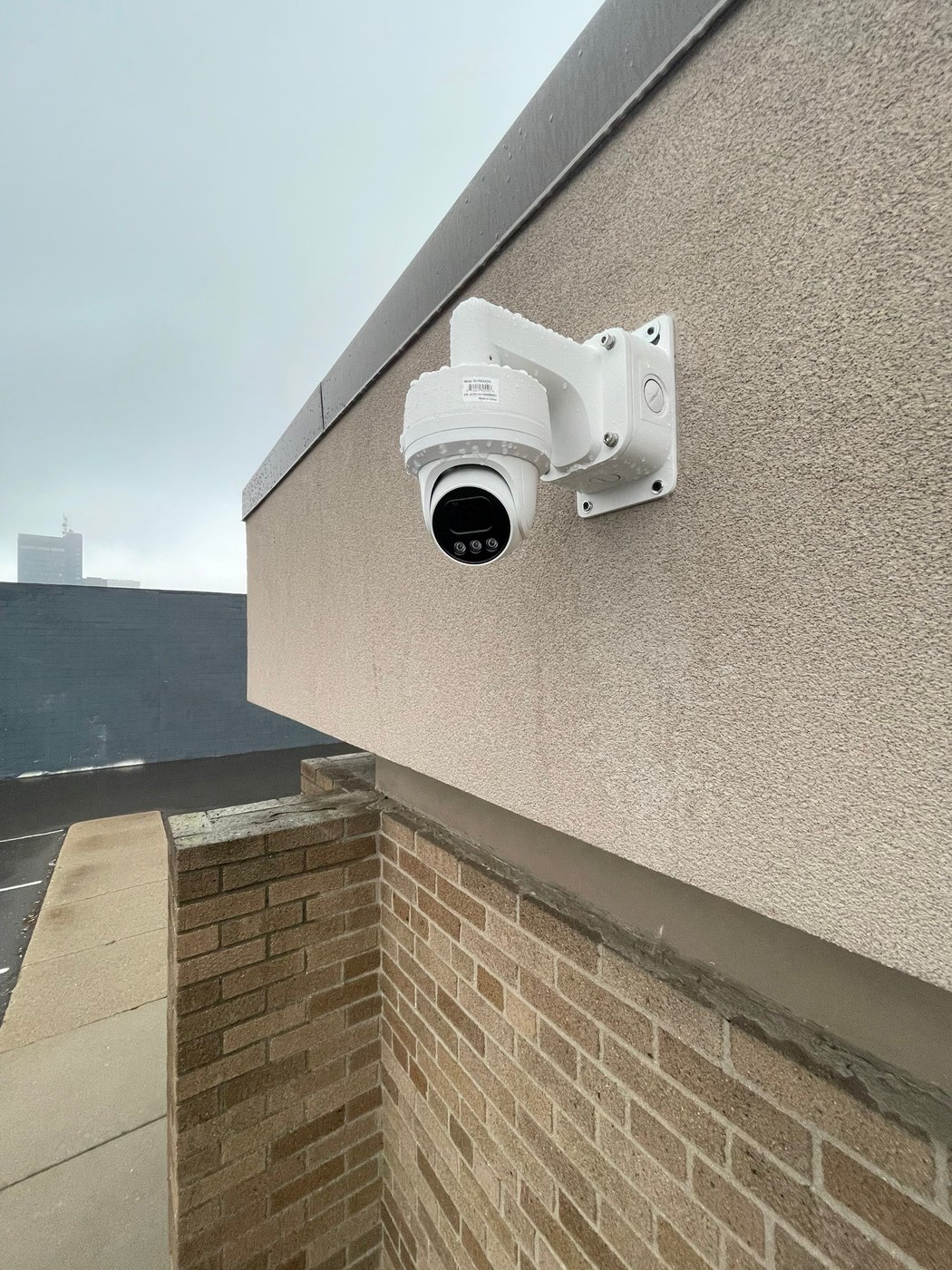 PTZ dome security camera mounted on a brick building exterior corner at a Michigan house of worship — installed by Michigan Security Systems