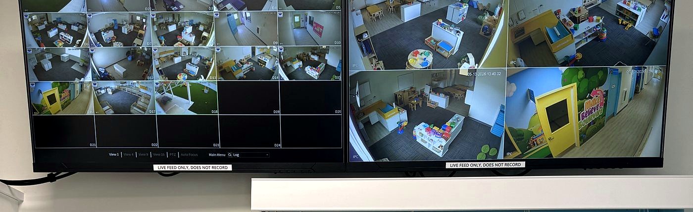 12-camera security monitor displaying warehouse surveillance feeds on Acer display — remote monitoring security camera system Michigan — Michigan Security Systems