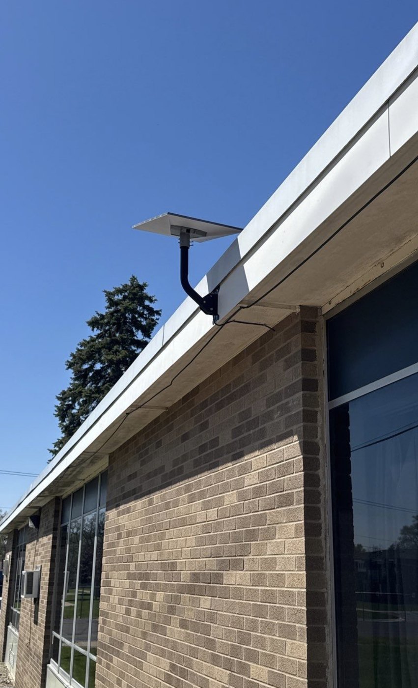 Starlink satellite dish professionally mounted on a commercial brick building by Michigan Security Systems, an authorized Starlink installer serving Michigan