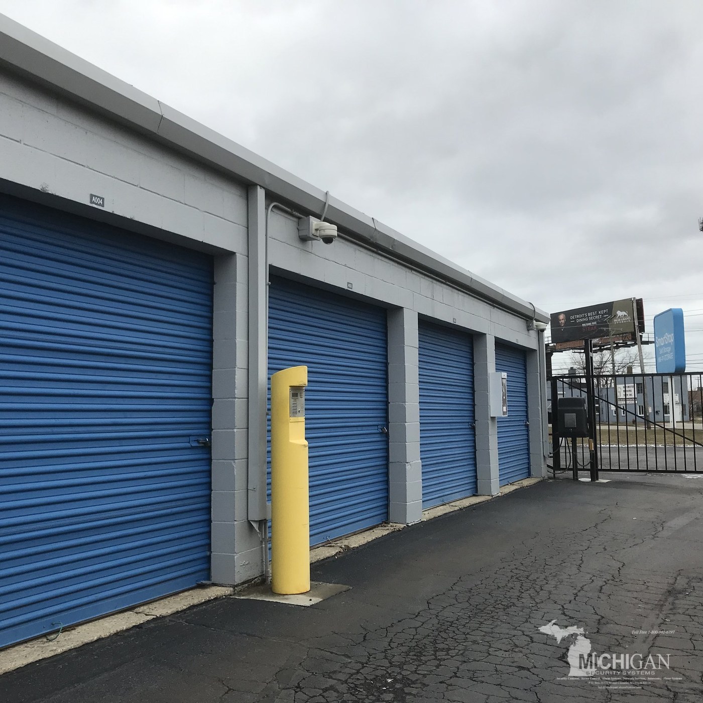 Security camera mounted under the roofline of storage unit doors at MyPlace Storage in Westland, Michigan — repaired and reprogrammed by Michigan Security Systems