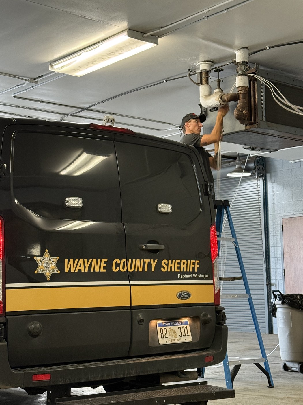 Michigan Security Systems technician working near the vehicle garage at River Rouge Police Department during network cabling installation